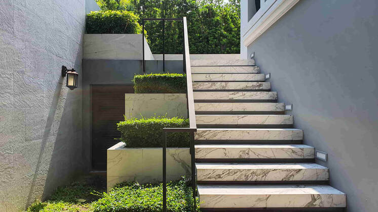 This luxury Richmond home had concrete stairs installed that were designed to mimic marble. The marble look matches perfectly with the exterior of the home.